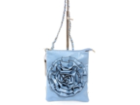 Crossbody bag has a top zipper closure, a detachable strap and a large flower detail. Made of faux leather.