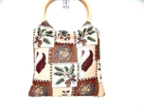 Cotton Tapestry Bag made with a wood double ring handle. Bag has a patchwork pattern.