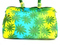 Leaf plant inspired duffle type beach bag. Bag has a double handle and a top zipper closure.  Made of 100% Cotton. 