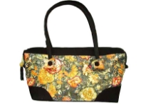 Double strapped fashion bag embellished with a beautiful flower design and a top zipper closure. 