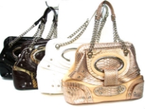 Designer Inspired Studded handbag has an metallic animal print pattern, a double handle with chain detail and a top zipper closure. Made of PU (polyurethane).