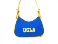 UCLA Nylon Collegiate Licensed Hobo Bag is made from fabric. It has a zipper and double adjustable handles. 
