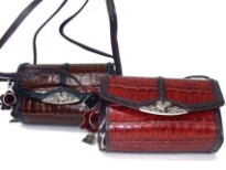 Genuine Leather with long strap like handle, leather trim in contrasting color all over the bag.