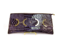 Croco embossed PVC clutch Bag has metal details and a magnetic closure and a an inside zipper closure.