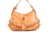 Fashion shoulder bag has a top zipper closure, a single strap and layered frill in same fabric with stud details on it. Made of PVC.