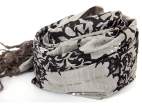 Beautiful Black and Grey colored scarf has horizontal open weave pattern. Long twisted fringes completes this 100% viscose scarf. Classy scarf can also be teamed up with a formal dress as a shawl. Imported. 