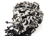 This 100% wool scarf in ivory color has artistic abstract figures print on it in black color. Has twisted fringes at its edges. Imported. Dry clean only.