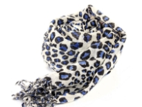 Black & blue leopard spots enliven this ivory colored scarf cast in 100% wool. Decorated with twisted fringe at the ends. Imported. Dry Clean only. 