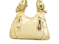 Designer Inspired Hobo Bag has metal accents and a double handle. Bag has a zipper closure. Made of PU (polyurethane).