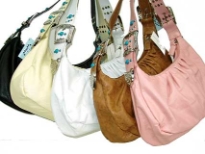 This shoulder bag is made of faux leather material. It has a single strap bag with a soft belt buckle strap  with turquoise studs and a top zipper closure. 