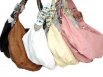 This bag is made of polyurethane material. It is a single strap purse with a belt buckle like strap and top zipper closure embelished with turquoise like studs.  