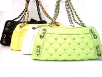 Designer Inspired Shoulder Bag with checkered pattern and studded details has a zipper closure and a double handle. Bag has whole details. Made of faux leather.