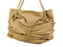 Spacious fashion shoulder bag has a ruched front, top zipper closure and a double handle. Made of PU.