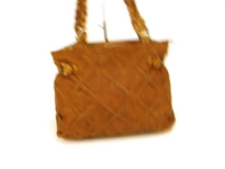 Designer Inspired Lattice-Finish Handbag has a zipper closure and a braided double handle. Made of faux leather.