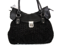 Shoulder bag is adorned with abstract fabric mini roses, has a double handle, top zipper closure and an elegant twist lock closure. Made of PVC.