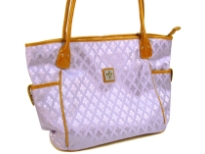 Fleur De Liz Licensed Jacquard Handbag. This spacious broad bag with two side pockets with button closure has leather trim bordering the bag & has double handle. Top zipper closure.
