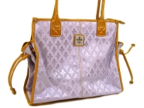 Fleur De Liz Licensed Jacquard Handbag. This spacious bag in jacquard material has leather trim bordering the bag & also hanging tussles on the sides. Top zipper closure.