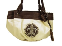 Fleur De Liz Licensed PVC Handbag with braided double handle, hanging tussle in the front, broad leather trim on the top in contrast color. Fleur De Liz logo in the center with studded rhinestones.