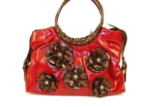 PVC Flower Handbag with round double handle & belt accents on the sides of the bag. Floral patchwork in contrasting color makes the bag very trendy & fashionable.