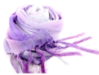 This lightweight 50% viscose & 50% polyester scarf in purple, lilac & white shades with silver stripes running through it can be used all year around to give an edge to your outfit. Long knotted tussels on its edges. Imported.