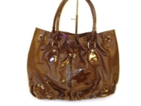 Designer Inspired Handbag with drawstring closure and a double handle has flowered applique details and ruches at bottom. Made of PU (polyurethane).