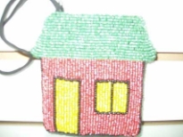 Multi color beaded coin purse in the shape of hut. Top zipper closure with wrist strap also. Imported.