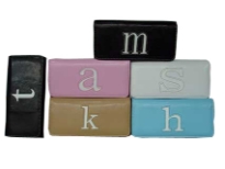Ideal wallet for everyday use has a single letter detail at center. Wallet has a snap/magentic closure. Made of faux leather.