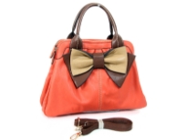 Bow accent dual compartment fashion handbag. Top zipper closing.  Adjustable shoulder strap included. Back zipper pocket.