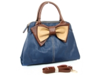 Bow accent dual compartment fashion handbag. Adjustable shoulder strap included. Back zipper pocket.