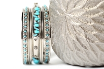 This sparkling silver metal 9 pieces set can be matched with any kind of outfit during day or at night. Set includes 6 plain thin bangles, 2 similar round beads bangles & one wide metal pattern bangle with turquoise beads. 