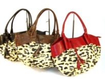 Designer Inspired Shoulder bag with top zipper closure and a double handle has an animal print pattern design and a single color band with tassel detail. Made of faux leather.