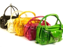 Designer Inspired Handbag with metallic texture and multiple zipper details has an external pocket with lock and key detail. Bag has a top zipper closure and a double handle. Made of PU (polyurethane).