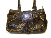 Designer Inspired Handbag has an animal print pattern along straps and shiny leather like texture. Bag has a top zipper closure and belt flap with a twist lock closure. Bag has a double handle. Made of PU (polyurethane).