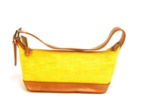 Single strapped straw bag has a top zipper closure and a single strap.