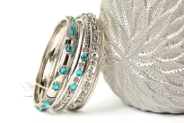 Silver colored 8 pieces fashion bangles set has turquoise beads on 2 of the bangles which gives an edge to this set. 5 thin bangles with 2 bangles have metal floral pattern & one wide bangle has turquoise stones. Hand crafted in India by expert artisans.  