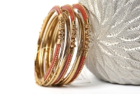Beautifully hand crafted 9 pieces set of stylish bangles includes 3 rust colored resin bangles encrusted in gold colored metal frame & 6 skinny bangles either etched or plain. Rich color of these bangles makes them attractive. 