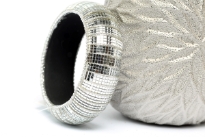 Wide cuff rounded fashion bangle in Silver color has shiny translucent mirrors all over it. Silver makes little sections on the bangle. Hand crafted by expert artisans in India. Durable and high quality construction.