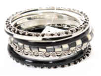 This seven pieces bangles set in silver metal includes different designs of bangles which are painted or studded and in varied widths. Can be matched withe any kind of formal or casual outfit to give that funky look. Made in India.