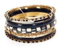 This seven pieces bangles set in silver metal includes different designs of bangles which are painted or studded and in varied widths. Can be matched withe any kind of formal or casual outfit to give that funky look. Made in India.