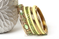Chunky looking assortment of 10 pieces  including 4 thin bangles, 3 lime green resin bangles, 2 thin green bangles & one wide metal pattern bangle with green rhinestones on it. This set can light up any outfit. 