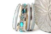 Chunky looking assortment of 10 pieces including 4 thin metal bangles, 3 periwinkle blue resin bangles, 2 thin  bangles with blue resin & one wide metal pattern bangle with turquoise rhinestones on it. This set can give funky look to any kind of outfit. 