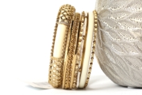 Gold Colored Metal Fashion Bangles Set consists of 8 pieces - one ivory colored wide bangle with metal mesh design, beaded thin bangles & patterned metal bangles also. Can be matched with any kind of outfit for that extra zing. 