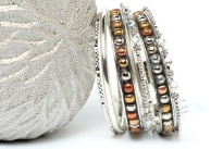 Trendy 7 pieces set of bangles in brass including 2 wide bangles with copper, silver, gold dots & 5 thin bangles which have their own metal pattern. Lightweight & durable to use.