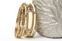 This Ivory with silver hand crafted fashion bangles set has 8 pieces - one broad resin bangle in mesh metal frame, one black resin bangle, 2 thin beaded bangles & 4 thin silver colored bangles. Matches with almost any kind of outfit & very durable.