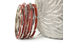 Elegant looking silver metal fashion bangles set of 12 pieces has small rust beads on 7 thin bangles, 3 thin silver bangles & 2 are resin bangles encrusted in silver metal frame. 