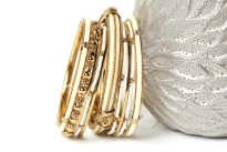 Beautiful Gold colored Metal Fashion Bangles Set can give that chic style to any kind of outfit at any time of the day. Set includes 3 thin gold bangles, 3 thin beaded bangles, 1 floral metal pattern bangle, 2 resin bangles in gold frame & one wide ivory resin bangle encrusted in gold frame. 