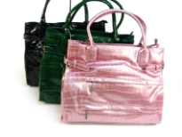 Croco Embossed shining patent leather spacious handbag with double handle, top zipper closure & belt like embellishments on the sides of the bag. Multiple zipper pockets in the front. Made of PU (polyurethane).