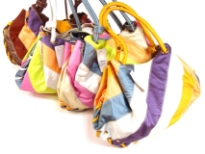 Designer Inspired Shoulder bag has multi color metallic stripes, a double handle and a magnetic closure. Made of faux leather.