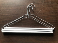 14.5G Laundry Dry Cleaners Strut Hangers. 16 Inches. These are brand new hangers used for pants made of white wire and a white cardboard tube which has adhesive on it to keep the pants from sliding off. Industrial quality that is made to last. These are 16" wide 14.5 Gauge wire.