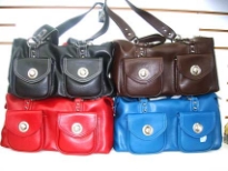 PVC Handbag has a top zipper closure and a double handle. Bag has outside pockets with twist lock closure.